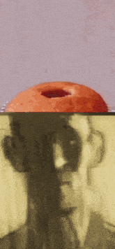 a blurry picture of a man 's face with a donut in front of it