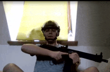 a man in a helmet is holding a gun