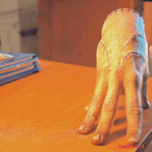 a statue of a hand giving the middle finger with the words trashtvtroll below it