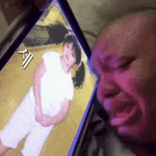 a picture of a little girl on a phone with chinese writing on it