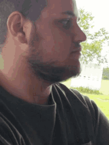 a man with a beard wearing a green shirt