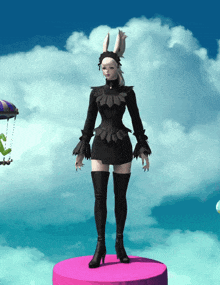 a woman in a black dress with bunny ears is standing on a pink pedestal