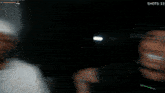 a blurry picture of a man in a white hat with the words shots 13 below him
