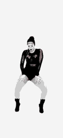 a woman is dancing with a hula hoop in her hand .