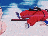 a man in a red jumpsuit is flying through the air with a monkey tail .