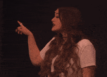 a woman with long red hair is wearing a white t-shirt that says " i love you "