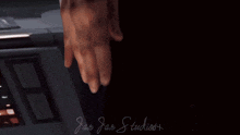 a man in a wig is holding a gun in front of a sign that says ' jan jar studios '