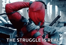 a man in a deadpool costume is holding a sword in his hand .