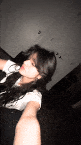 a blurry photo of a woman taking a selfie in a dark room