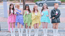 a group of girls standing next to each other with a car in the background and the words honeycam.org at the top