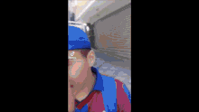 a blurry picture of a person wearing a hoodie and a hat .