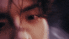 a close up of a person 's eye with a blurred background