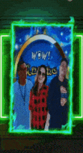 a group of people standing in front of a wow sign