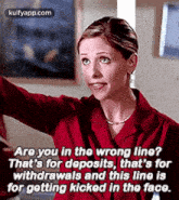 a woman in a red shirt is talking to another woman in a room .