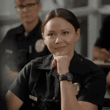 a woman in a police uniform has a watch on her wrist and a name tag that says ' smith '
