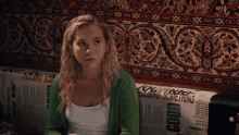 a woman sits on a couch with a newspaper that says good