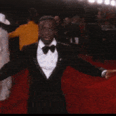 a man is doing a handstand on the red carpet