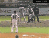 a baseball player with the number 62 on his jersey stands on the field