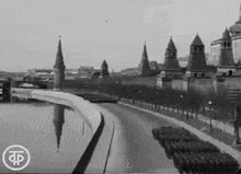 a black and white photo of a city with the letter f on the bottom right corner