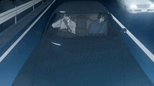 two men are driving a car on a highway at night with a white car behind them