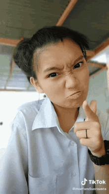 a girl is making a funny face and has a tiktok watermark on her photo