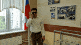 a man wearing sunglasses is talking on a cell phone in front of a flag