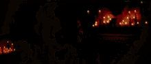 a man with a beard smiles in front of candles