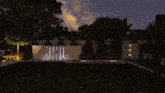 a rendering of a garden at night with a fountain