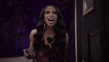 a woman in a black dress is making a funny face .