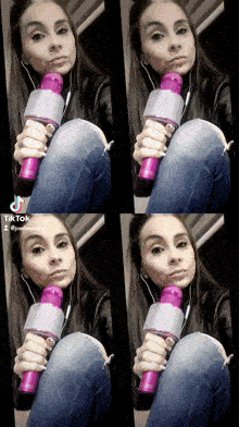 a woman is holding a purple microphone while wearing headphones and jeans