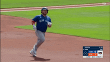 a baseball player in a blue jays jersey is running on the field
