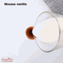 a glass filled with chocolate sauce is being poured into a cup .