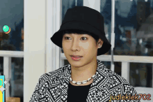 a man wearing a black hat and a necklace with the name judleklek702 on the bottom right