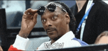 snoop dogg wearing sunglasses and a white shirt with the word wow on it