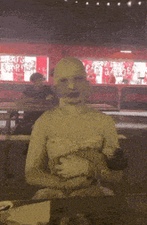 a person with a white mask on their face is sitting at a table