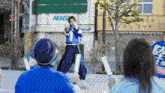 a man stands in front of a building with the word akagi on it
