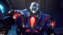 a man in a purple suit with red lights on his arms is standing in a dark room in a video game .