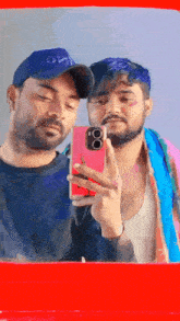 two men are taking a picture of themselves in a mirror one is wearing a hat that says sg