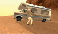 a man is pushing a camper van up a hill in the desert