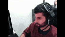 a man with a beard wearing headphones and a microphone
