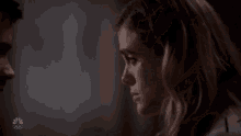 a man and a woman are looking at each other .