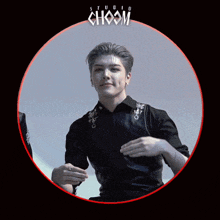 a man in a black shirt is standing in a circle with the word choom on it