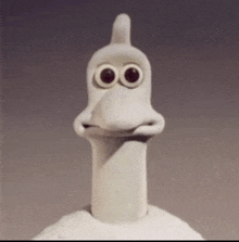 a close up of a cartoon character with big eyes and a long neck