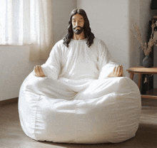 a statue of jesus sits on a bean bag chair