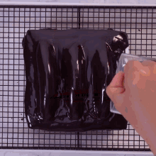 a person is pouring liquid on a piece of food