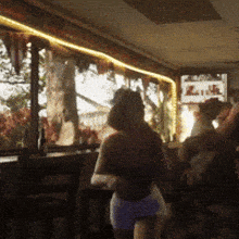 a blurry photo of people dancing in a room with a sign that says ' plaza '
