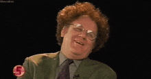 a man with red hair and glasses is laughing with a sticker that says bleecakes