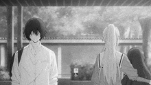 a black and white photo of a man and a girl standing next to each other .