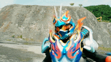 a blue and orange robot with flames on it 's armor