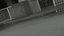 a person in a red and white outfit is walking on a street